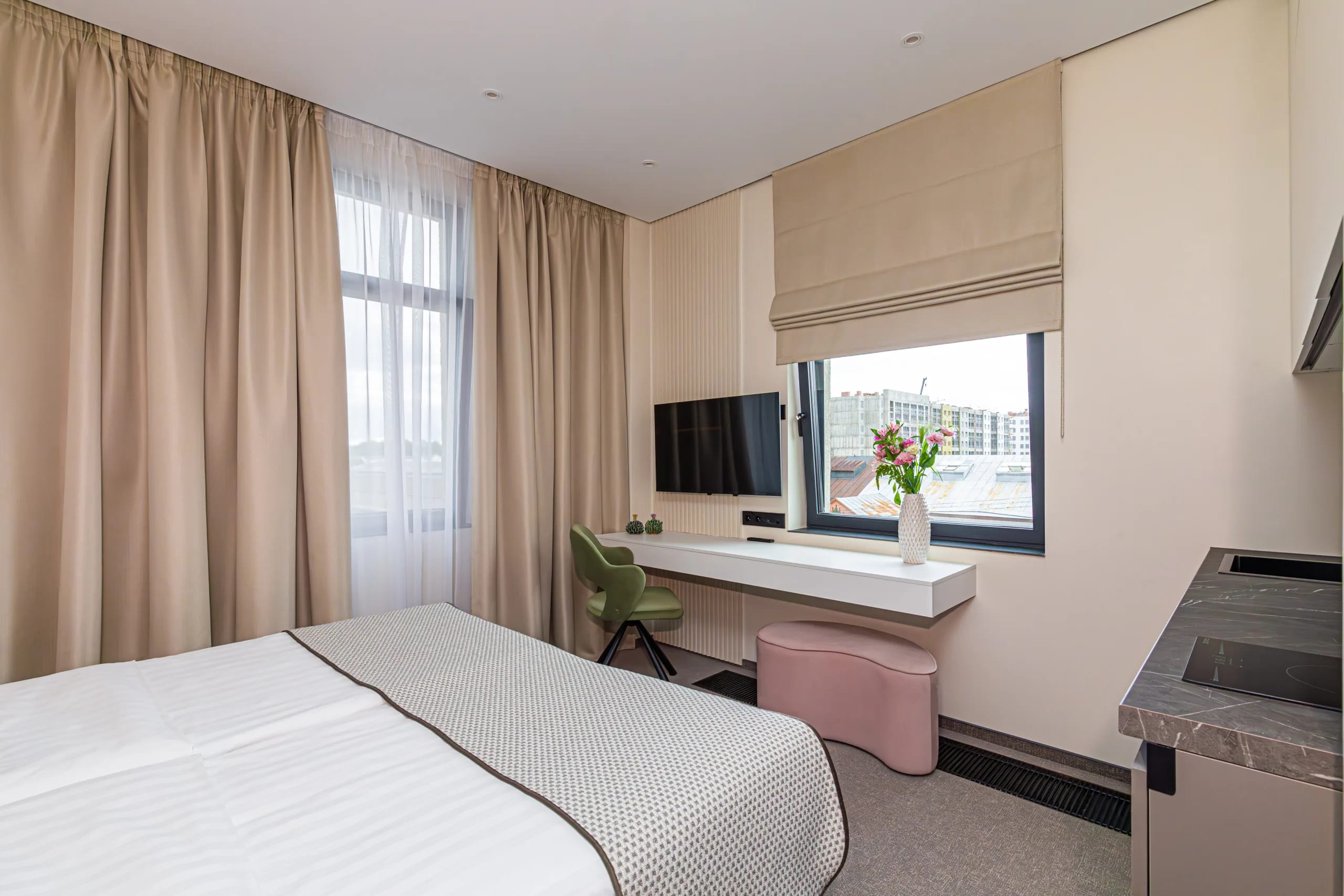 Standard room with a double bed: the sleeping area with a table by the window and a TV