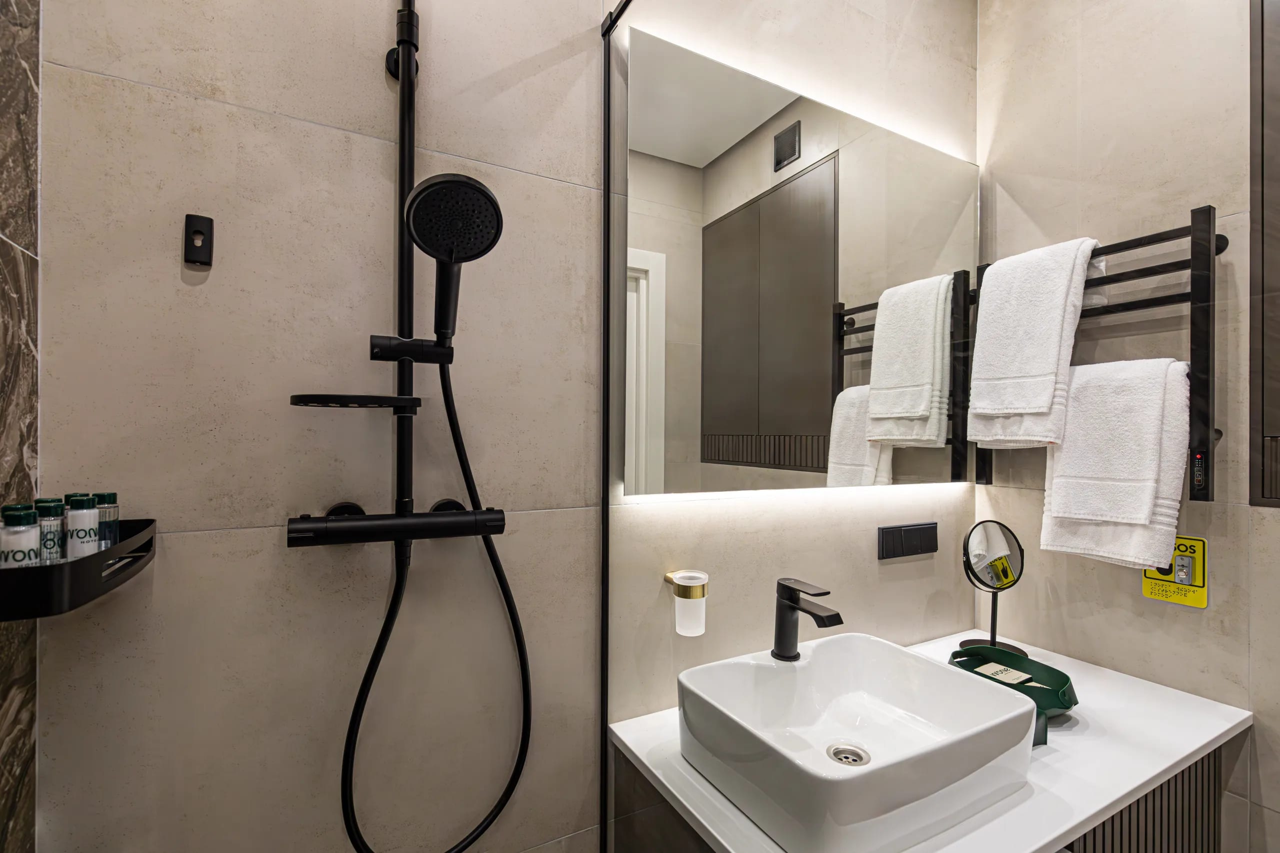 Standard room with a double bed: the shower area and washbasin, towels on the heated rail