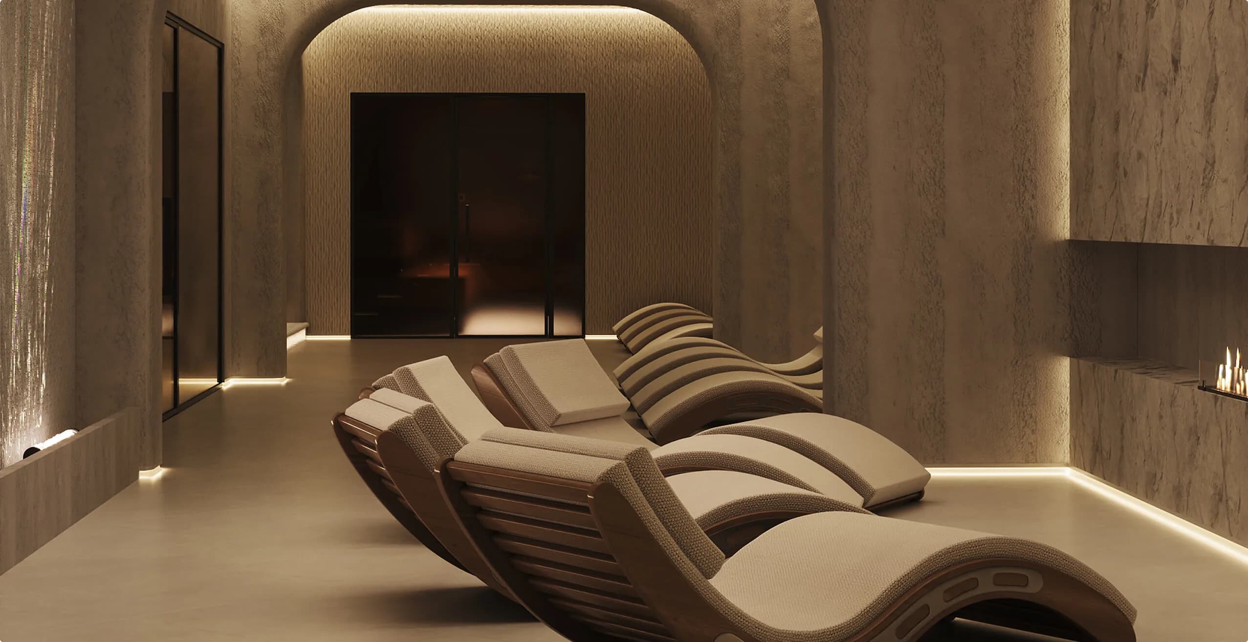 The hotel spa: loungers by warm lighting and stone walls